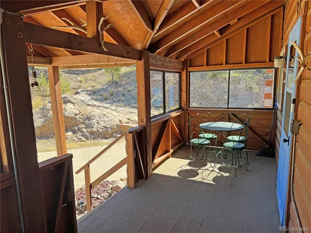 a view of a porch with furniture and a gate