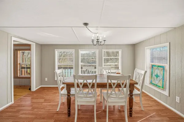 a view of a dining room with furniture wooden floor and chandelier