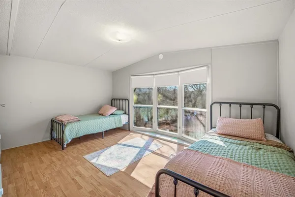 a bedroom with furniture and a window
