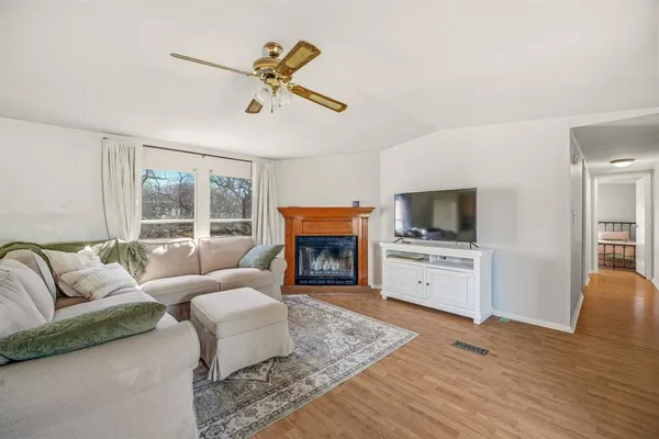 a living room with furniture fireplace and window