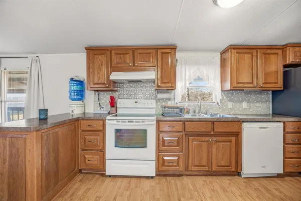 a kitchen with stainless steel appliances granite countertop a stove sink and cabinets