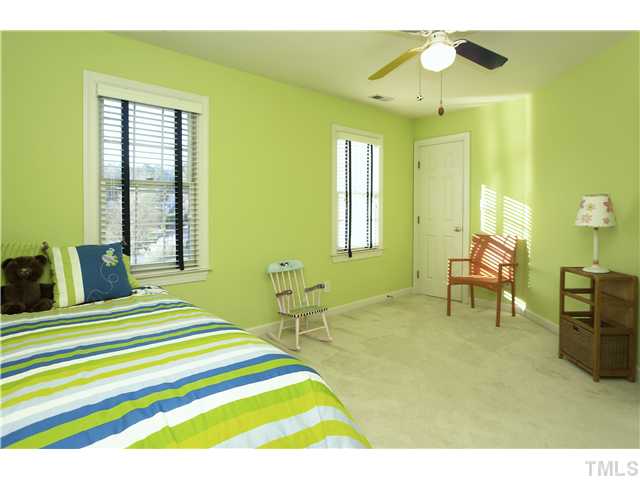 115 Skylark Way Raleigh, NC 27615 - Photo 13 of 17 a bedroom with a bed and a chandelier