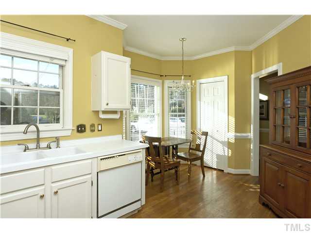 115 Skylark Way Raleigh, NC 27615 - Photo 4 of 17 a kitchen with a sink a counter top space appliances and cabinets