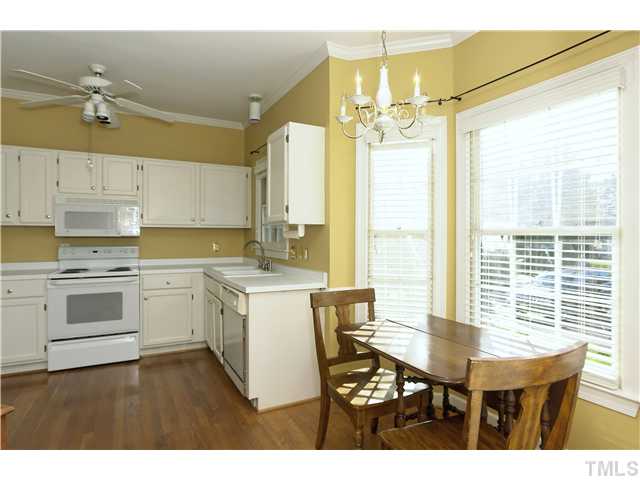 115 Skylark Way Raleigh, NC 27615 - Photo 5 of 17 a kitchen with a table chairs and white cabinets