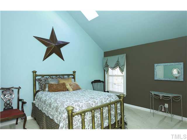 115 Skylark Way Raleigh, NC 27615 - Photo 9 of 17 a bedroom with a bed a dresser and potted plant