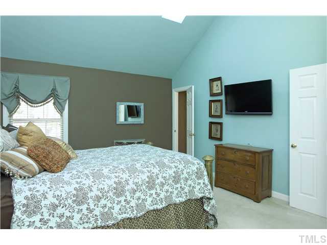 115 Skylark Way Raleigh, NC 27615 - Photo 10 of 17 a bedroom with a bed and a flat screen tv
