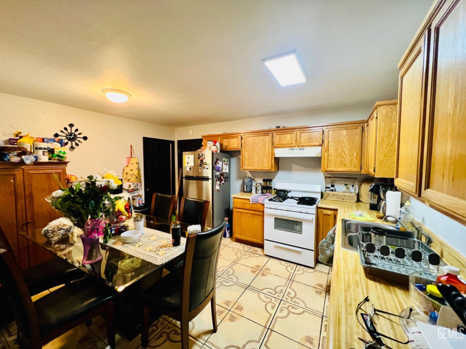 Undisclosed Address Lost Hills, CA 93249 - Photo 2 of 10 a kitchen with a table chairs stove and cabinets