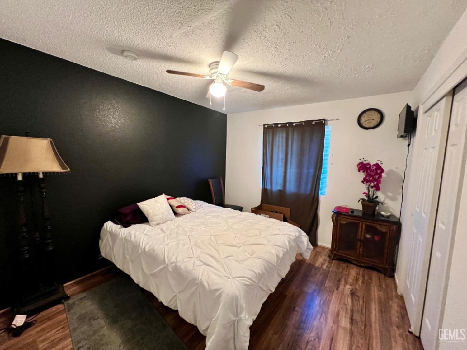 Undisclosed Address Lost Hills, CA 93249 - Photo 4 of 10 a bedroom with a bed and a dresser