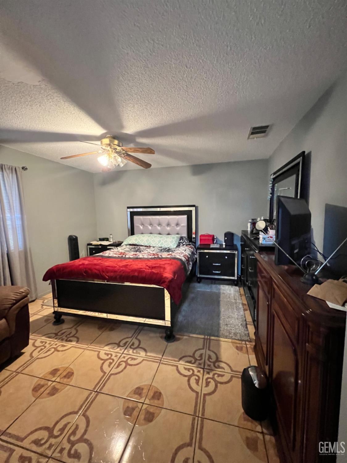 Undisclosed Address Lost Hills, CA 93249 - Photo 5 of 10 a bedroom with a bed and a flat tv screen on dresser