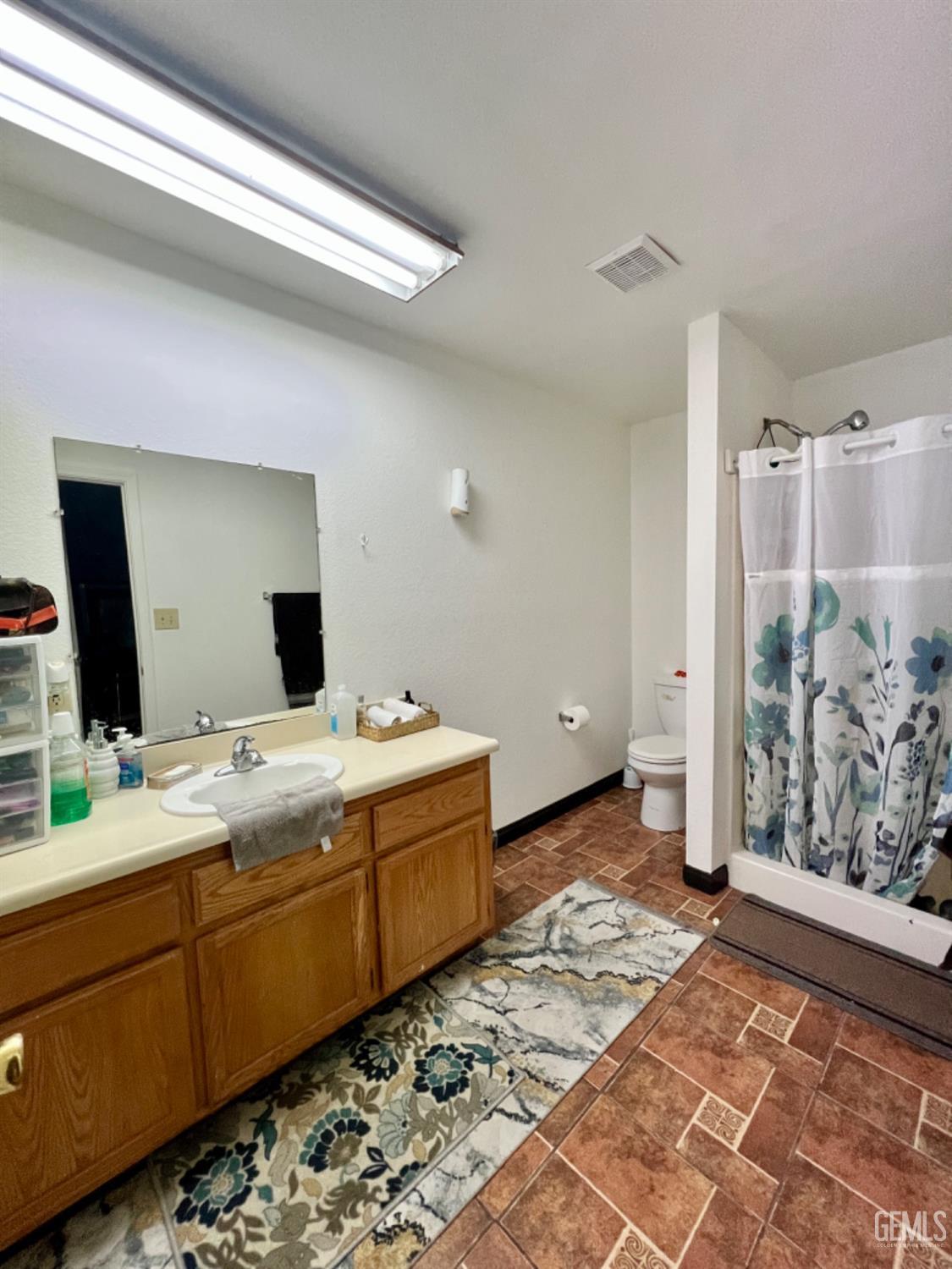 Undisclosed Address Lost Hills, CA 93249 - Photo 6 of 10 a bathroom with a double vanity sink and mirror