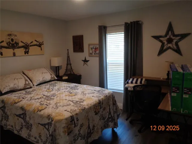 a bedroom with a bed and a dresser
