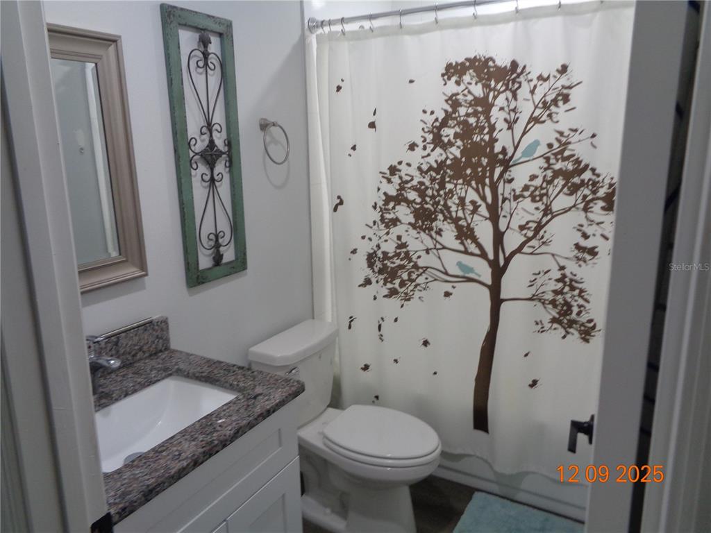 2380 8th Avenue DeLand, FL 32724 - Photo 16 of 31 a bathroom with a granite countertop sink toilet and shower