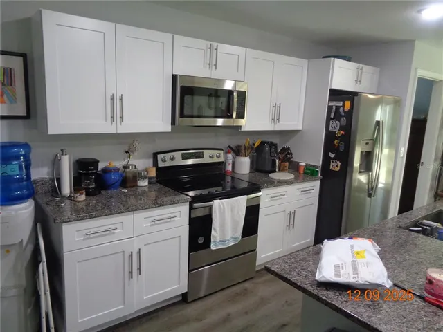 a kitchen with a stove and cabinets