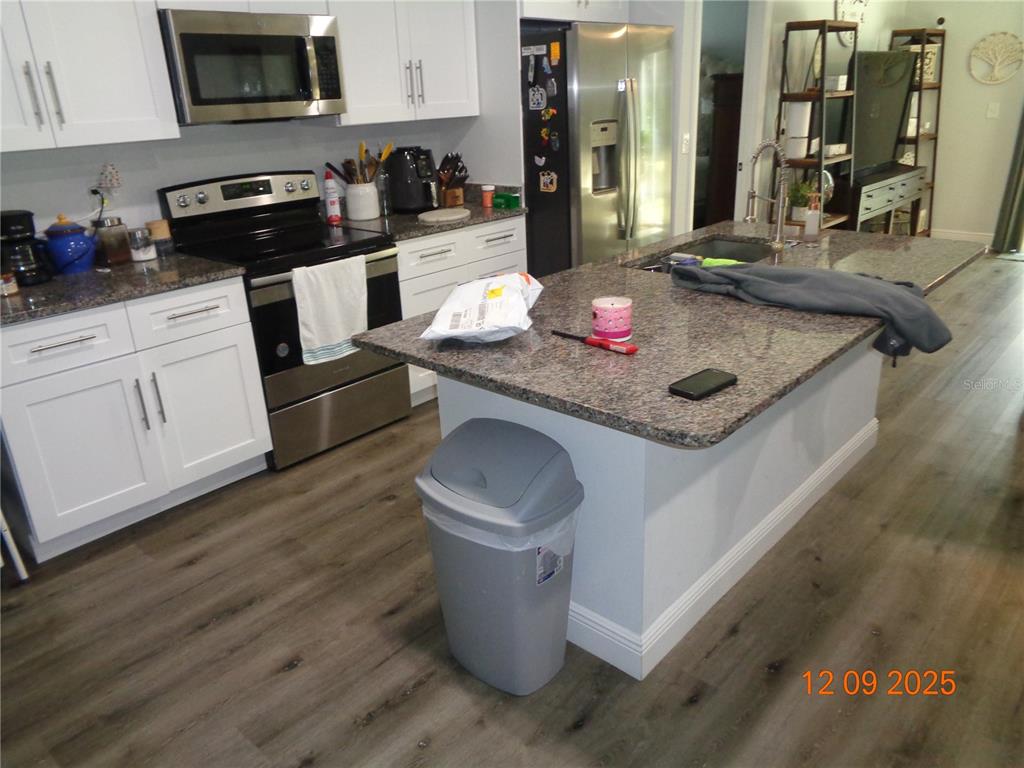 2380 8th Avenue DeLand, FL 32724 - Photo 23 of 31 a kitchen with a stove and cabinets