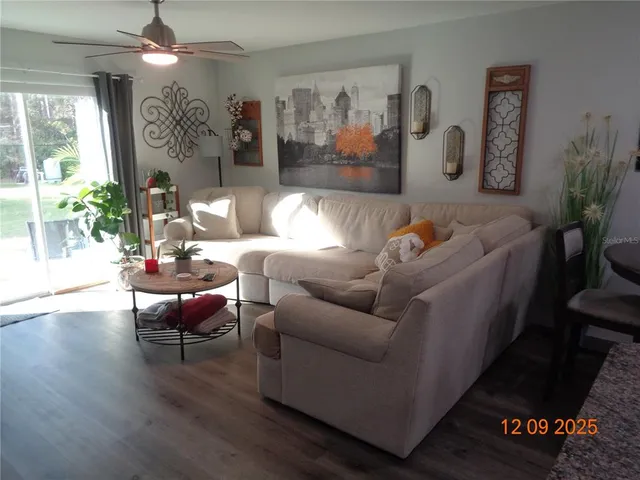 a view of a livingroom with furniture and a flat screen tv