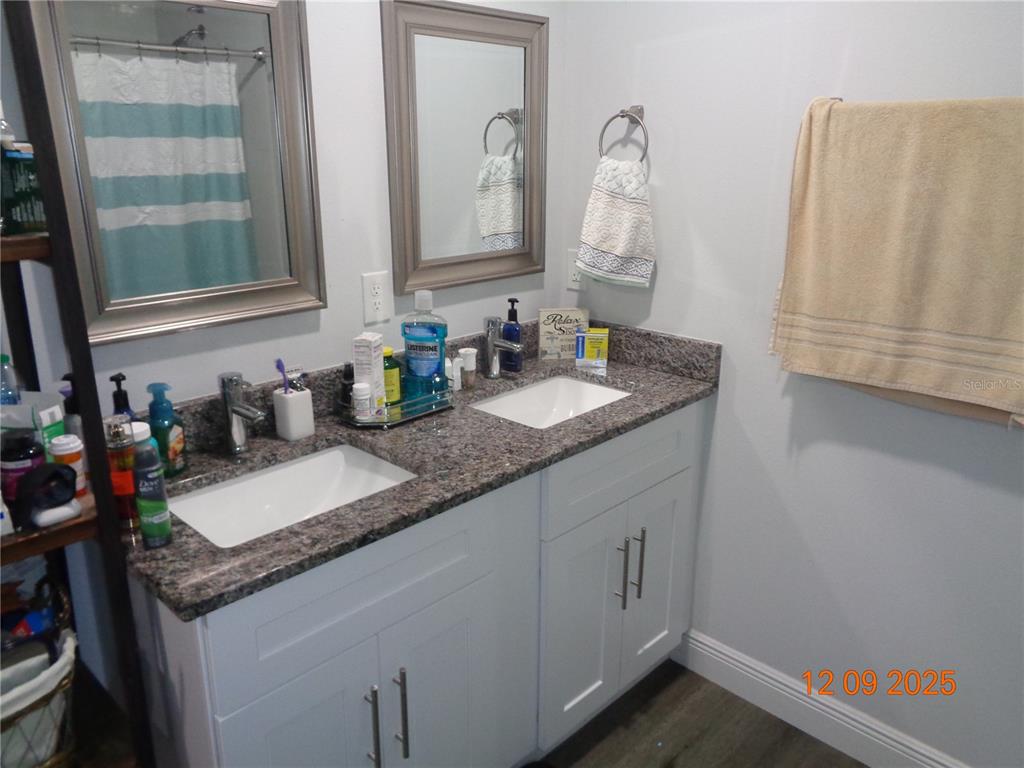 2380 8th Avenue DeLand, FL 32724 - Photo 30 of 31 a bathroom with a granite countertop sink and a mirror