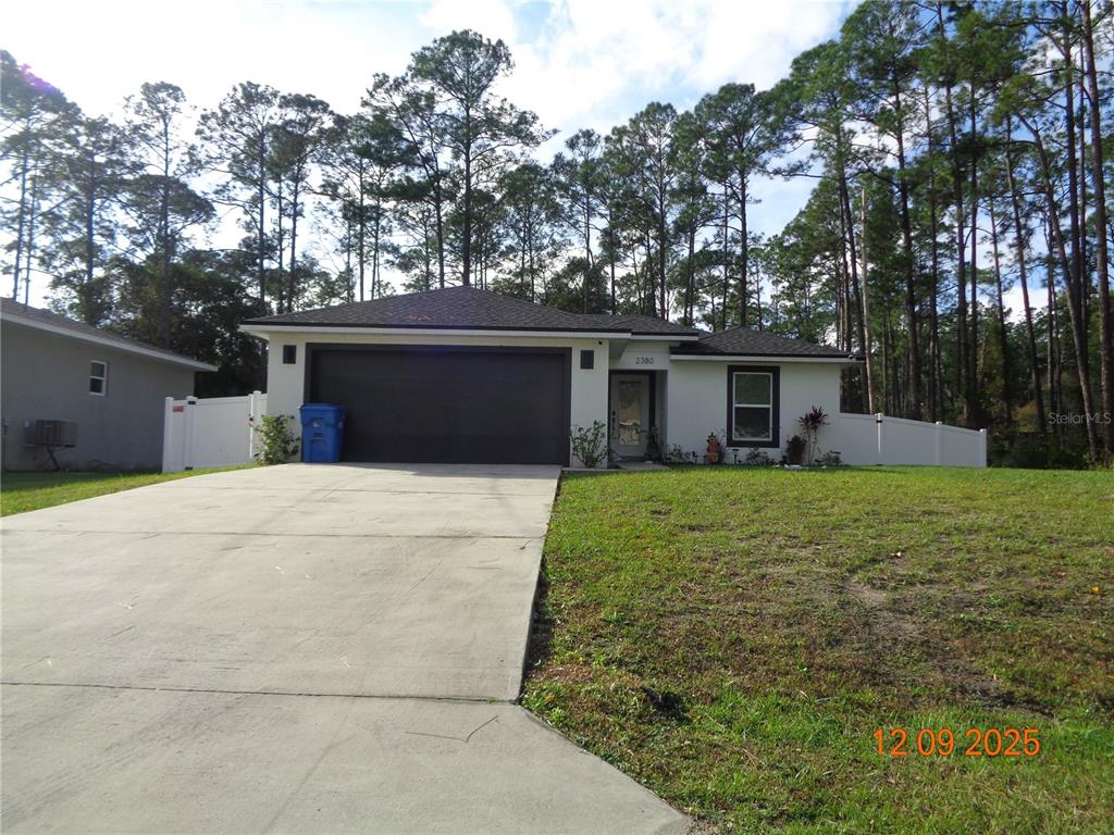 2380 8th Avenue DeLand, FL 32724 - Photo 5 of 31 a front view of house with yard and trees in the background