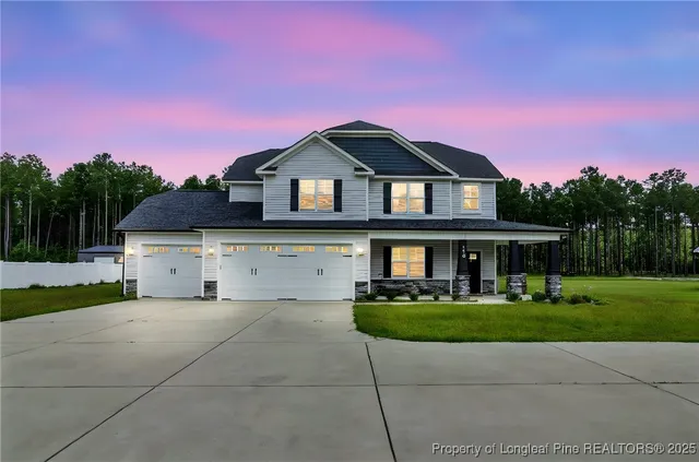 a front view of a house with a yard and garage