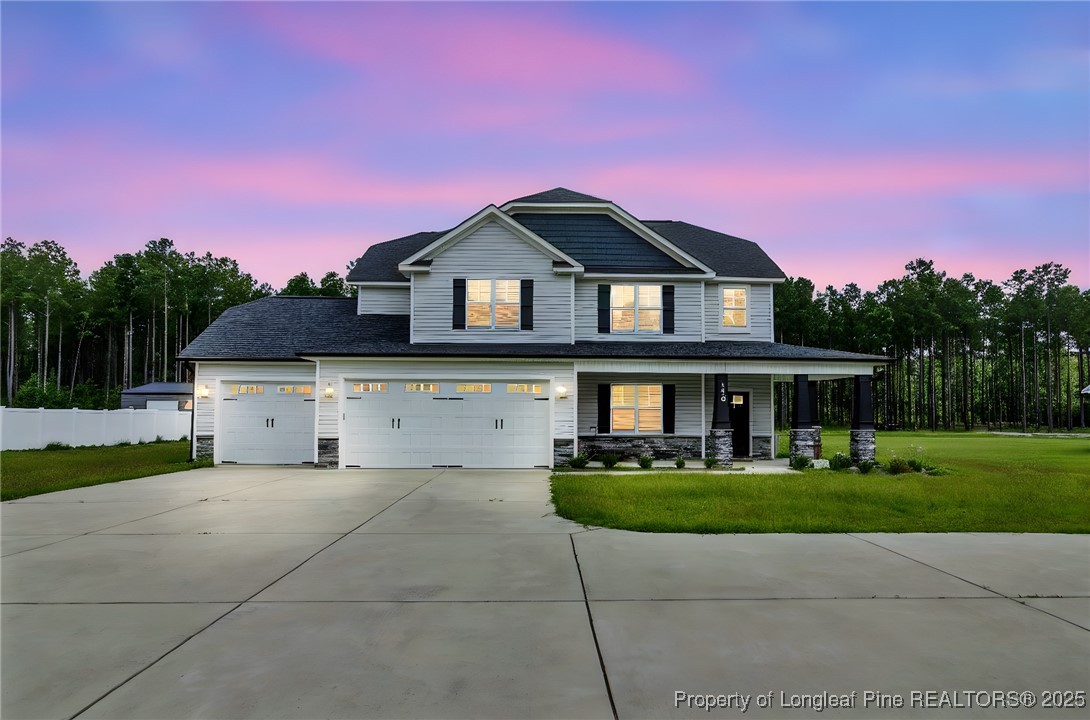 a front view of a house with a yard and garage