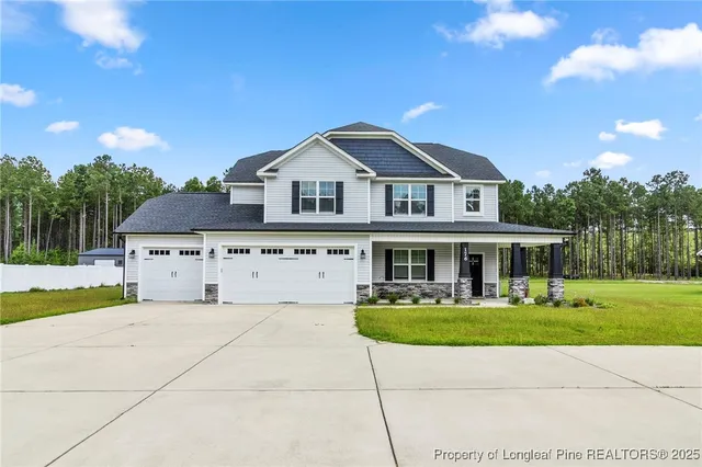 a front view of house with yard and green space