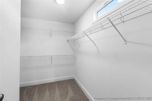 a spacious bathroom with a double vanity sink a mirror and a shower