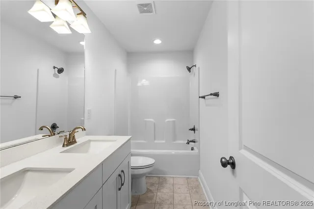 a bathroom with a sink a light fixture and a mirror
