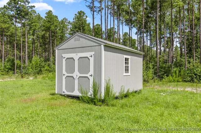 a view of a garden with a house in the background