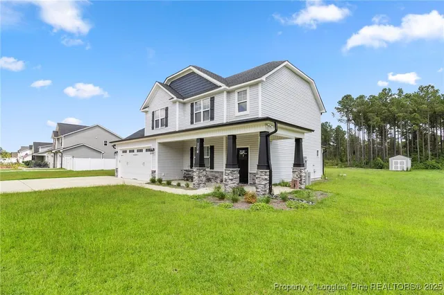 a front view of a house with garden and patio