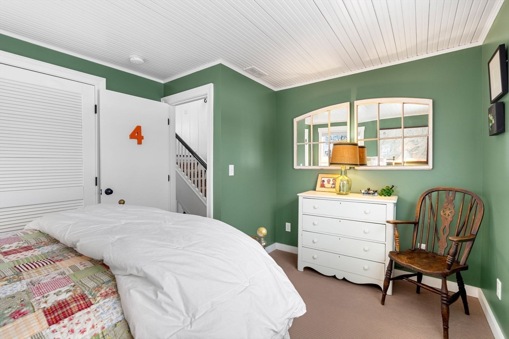 43 Ancient Highway Hampton, NH 03842 - Photo 29 of 42 a bedroom with a bed and a chair