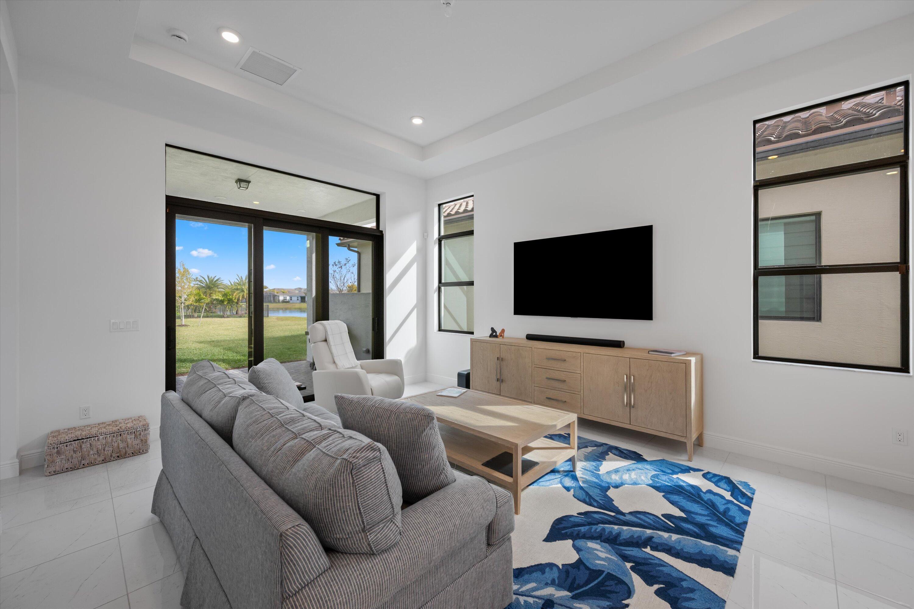 4891 Rivo Alto Circle Loxahatchee, FL 33470 - Photo 15 of 64 a living room with furniture and a flat screen tv