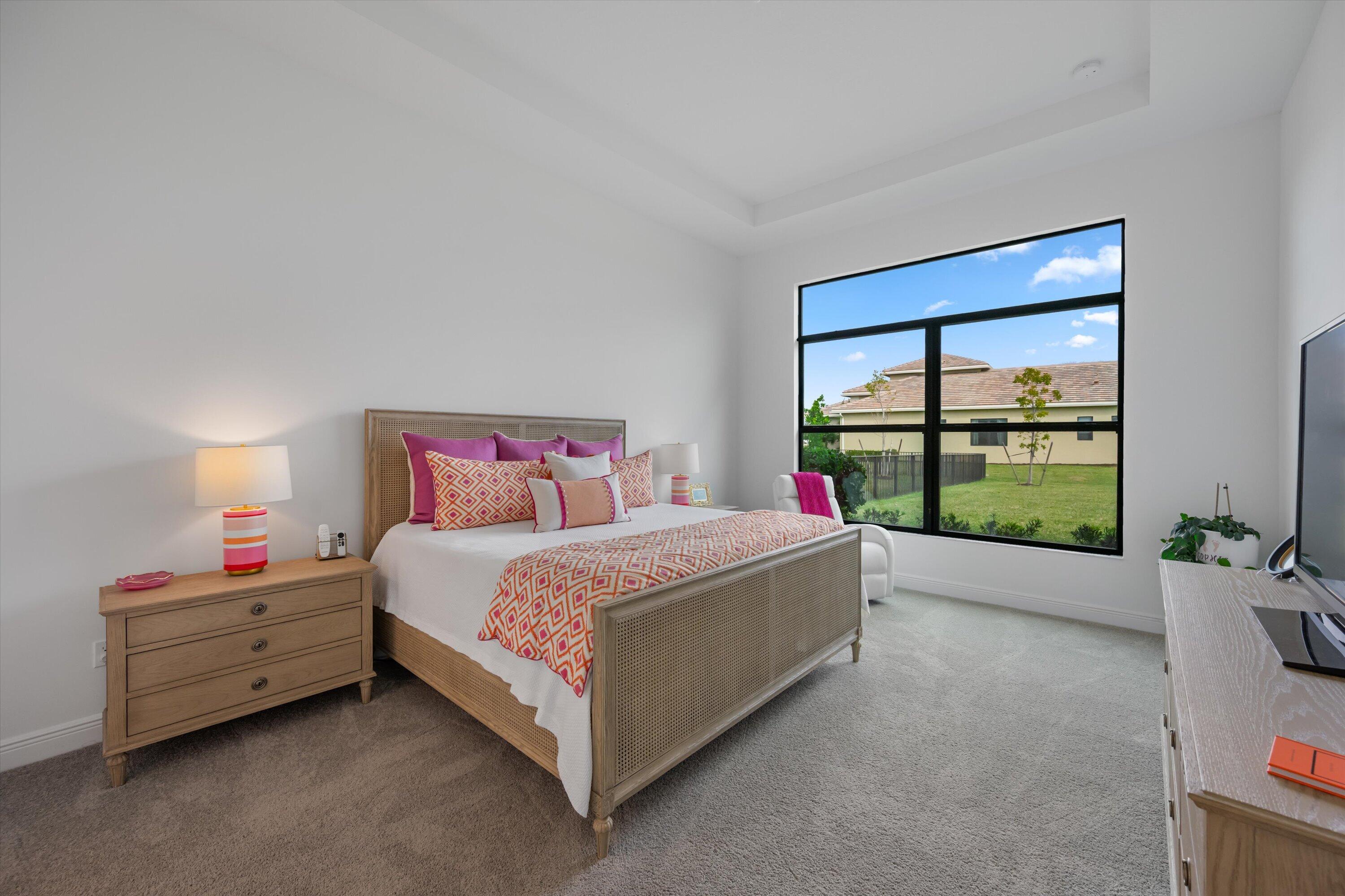 4891 Rivo Alto Circle Loxahatchee, FL 33470 - Photo 16 of 64 a bedroom with a bed and large window