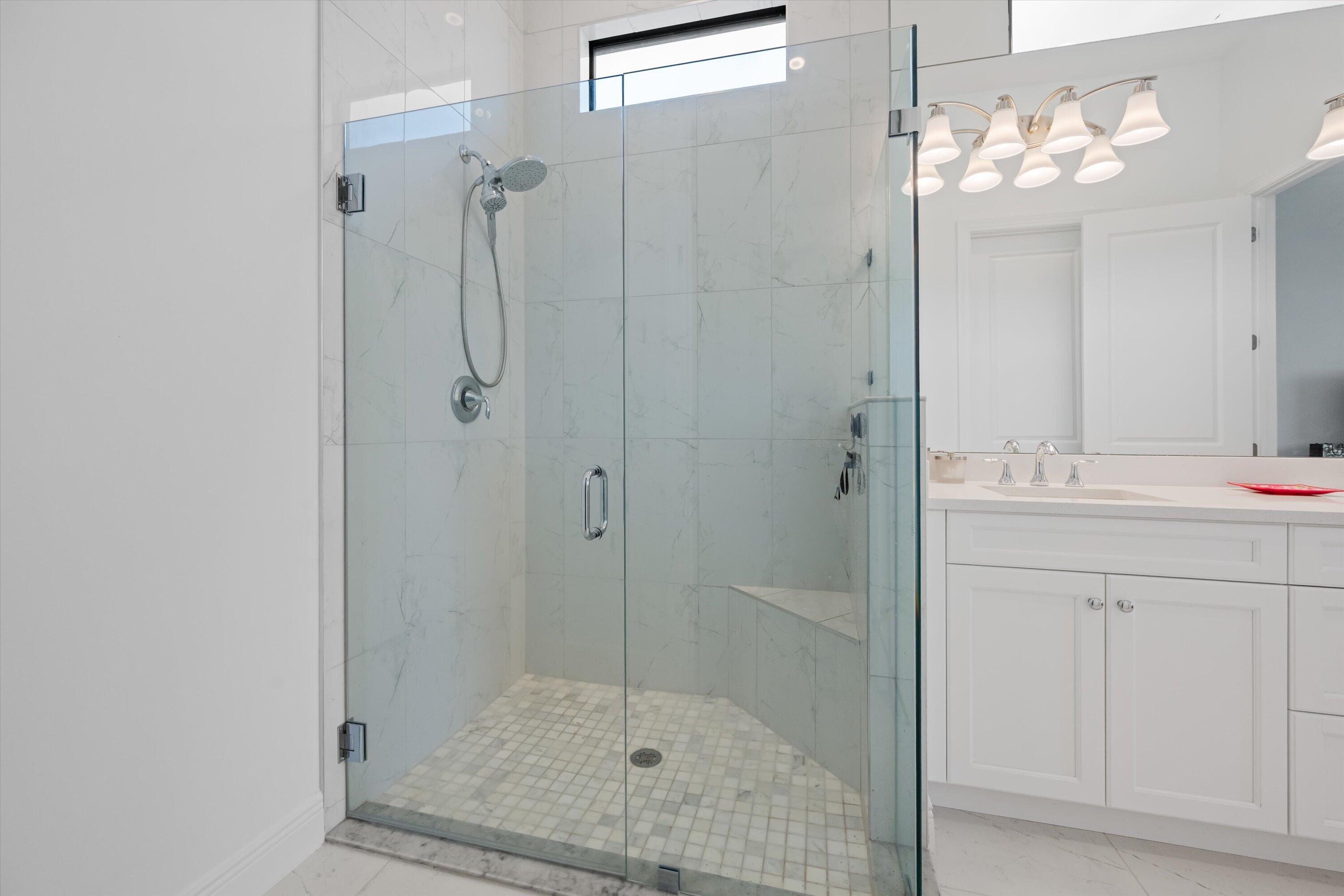 4891 Rivo Alto Circle Loxahatchee, FL 33470 - Photo 23 of 64 a bathroom with a shower sink and mirror