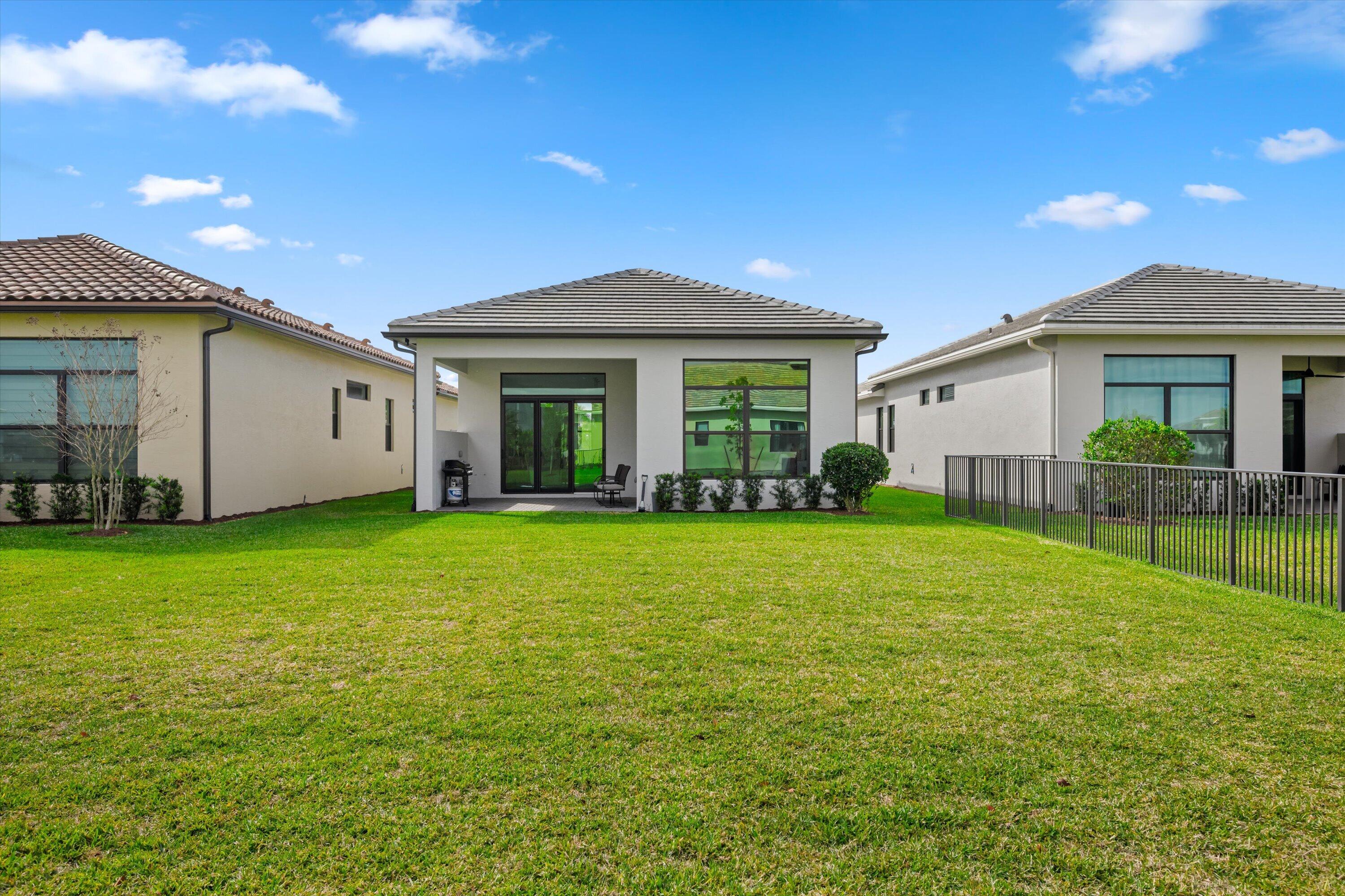 4891 Rivo Alto Circle Loxahatchee, FL 33470 - Photo 29 of 64 a view of a house with backyard and porch