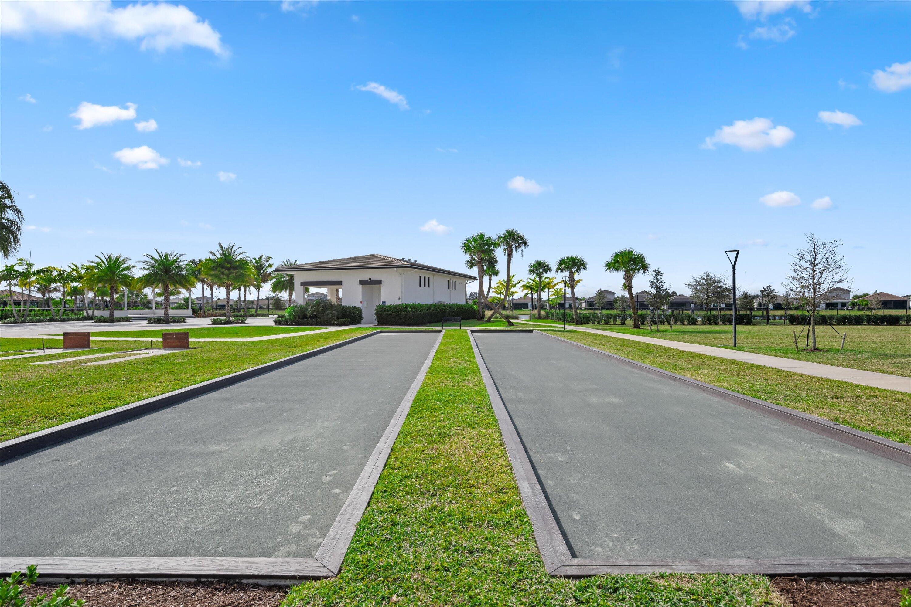 4891 Rivo Alto Circle Loxahatchee, FL 33470 - Photo 40 of 64 a view of building with swimming pool and yard