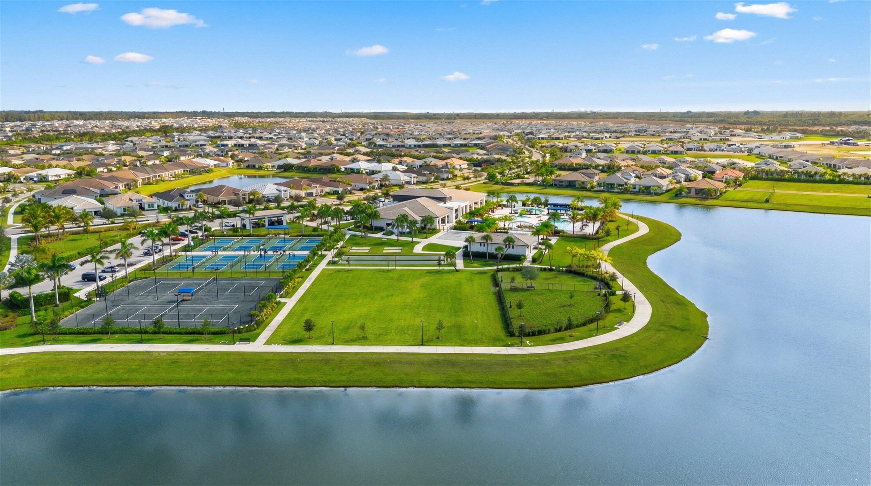 4891 Rivo Alto Circle Loxahatchee, FL 33470 - Photo 44 of 64 a view of a swimming pool with outdoor seating and yard