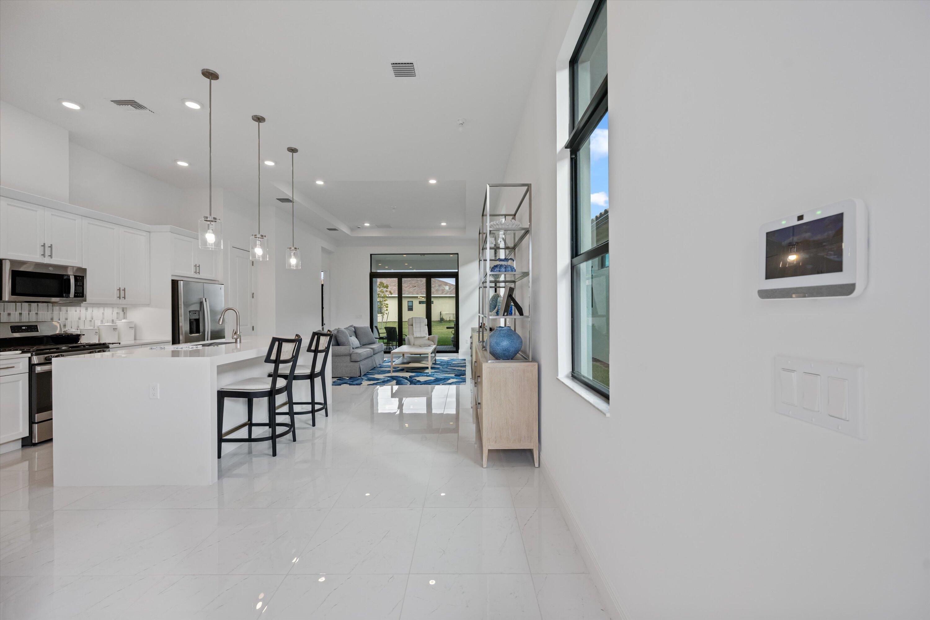 4891 Rivo Alto Circle Loxahatchee, FL 33470 - Photo 6 of 64 a dining room with furniture and a flat screen tv