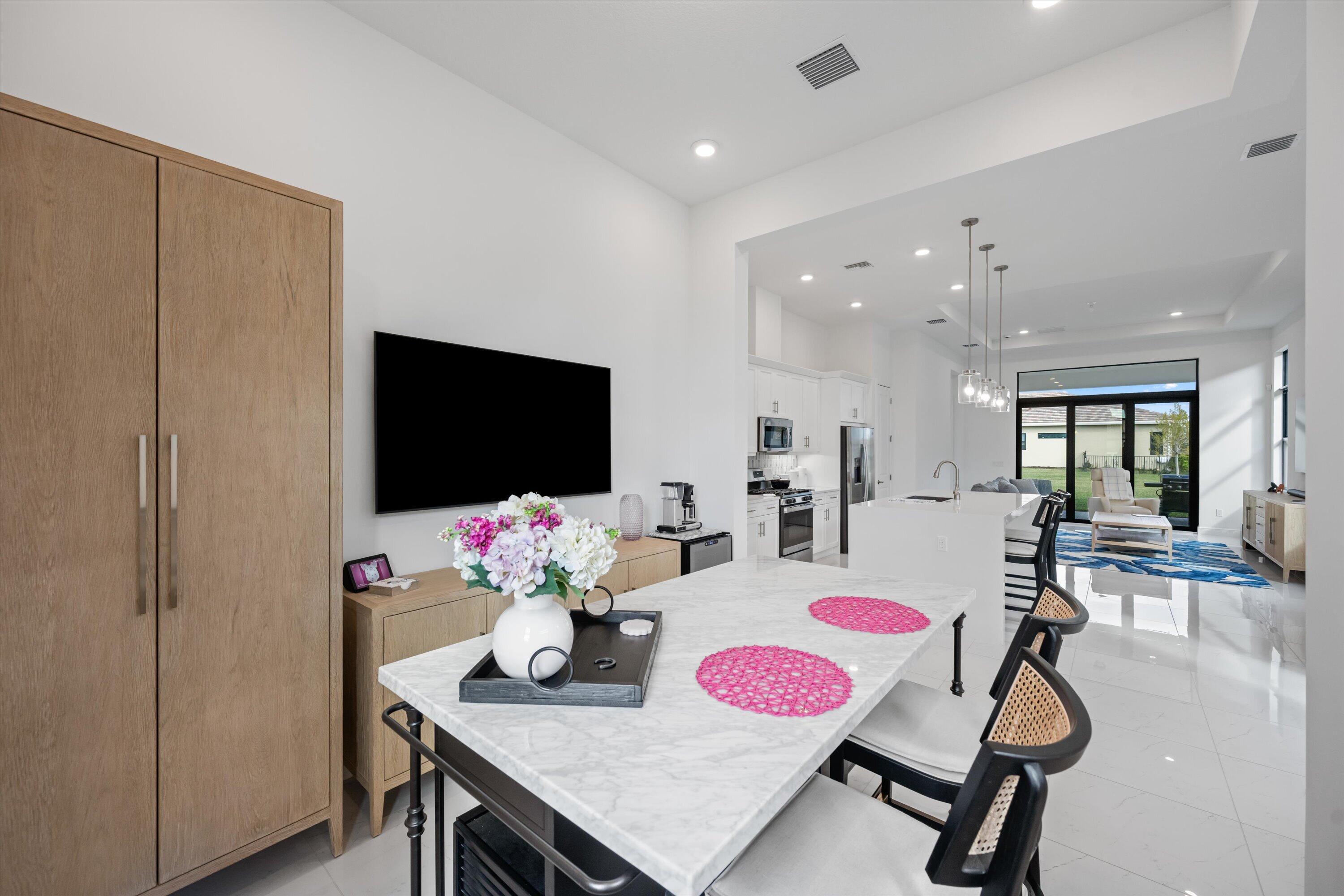 4891 Rivo Alto Circle Loxahatchee, FL 33470 - Photo 9 of 64 a dinning room with furniture and a flat screen tv