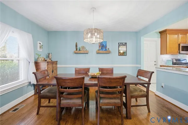 a view of a dining room with furniture window and wooden floor