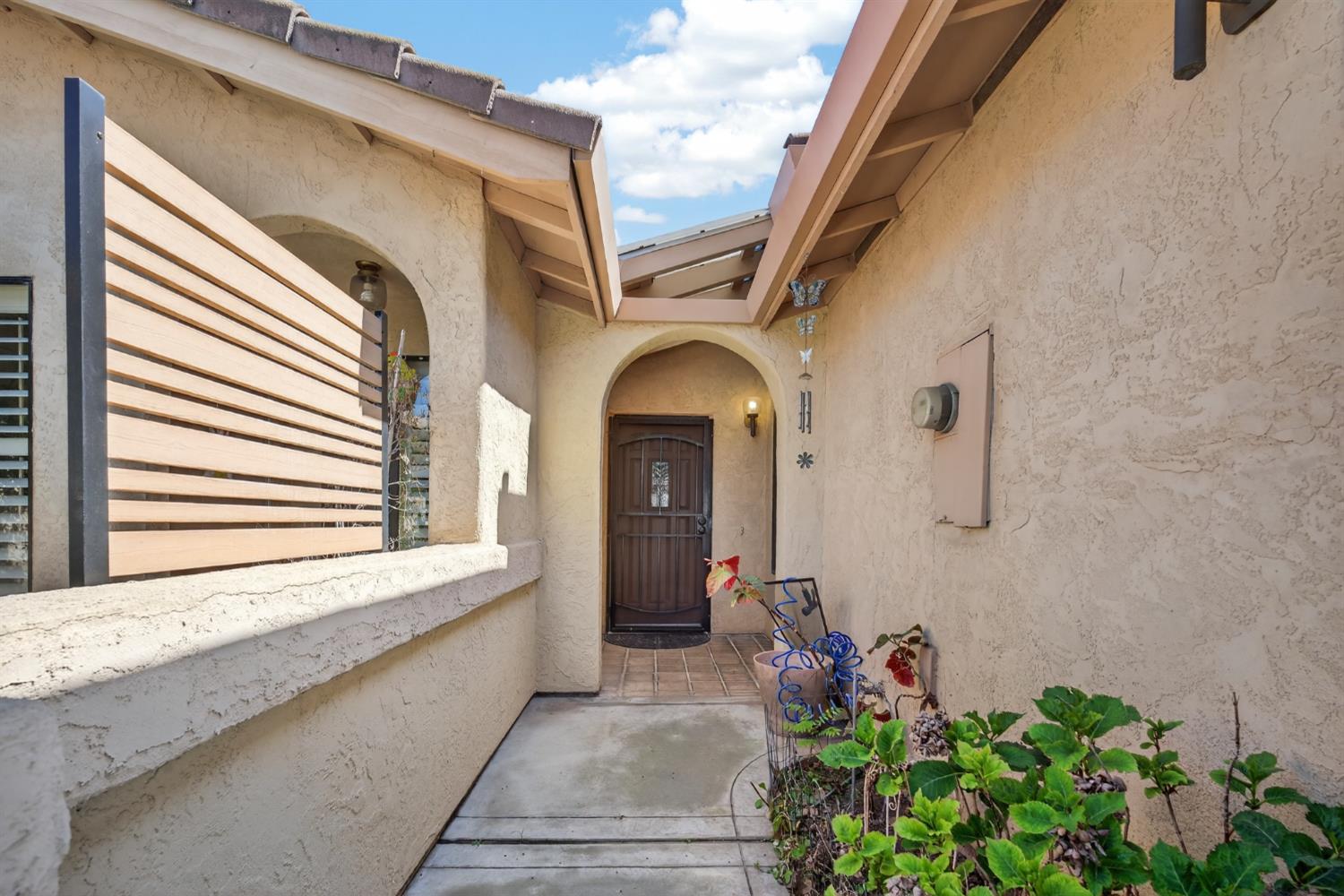 3072 Radford Way Turlock, CA 95382 - Photo 4 of 16 a view of a house with a potted plant and floor to ceiling window
