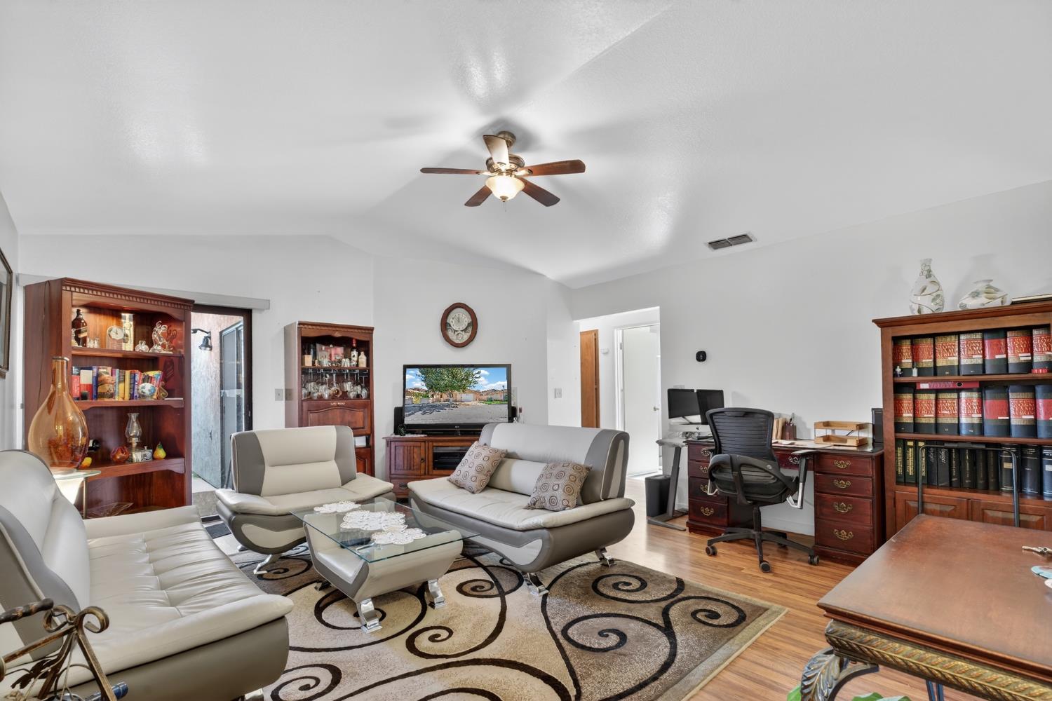 3072 Radford Way Turlock, CA 95382 - Photo 5 of 16 a living room with furniture a bookshelf and a window