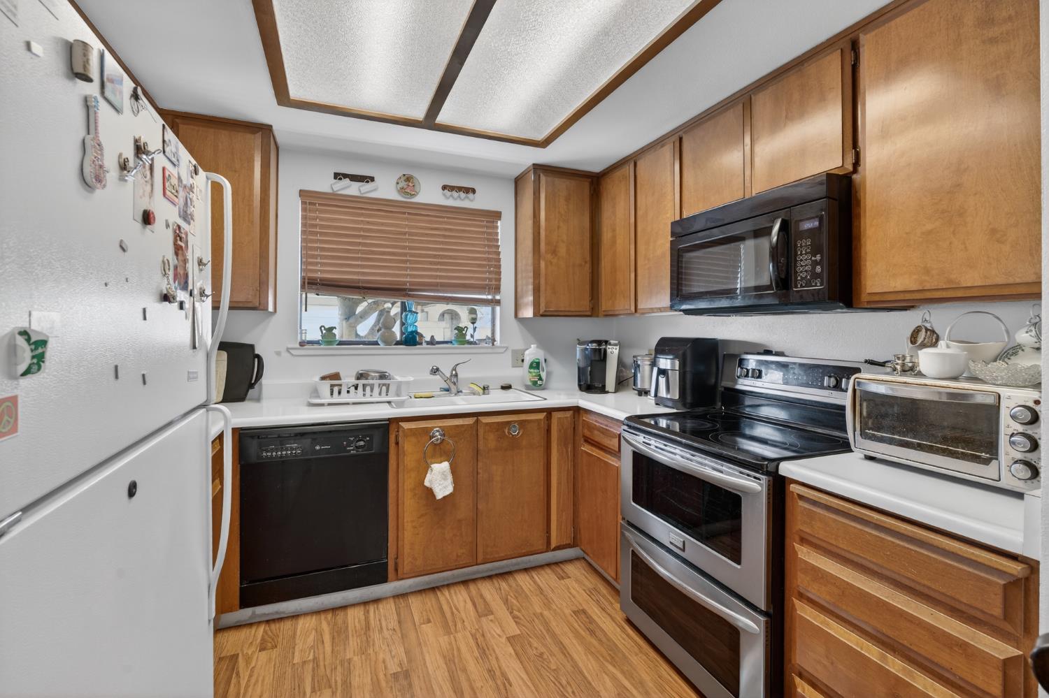 3072 Radford Way Turlock, CA 95382 - Photo 8 of 16 a kitchen with stainless steel appliances a stove sink microwave and cabinets
