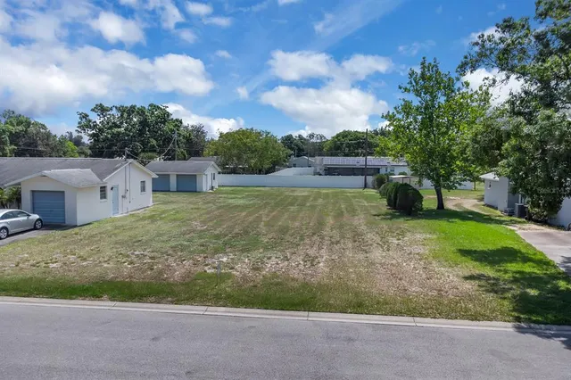 a view of a house with pool and a garden