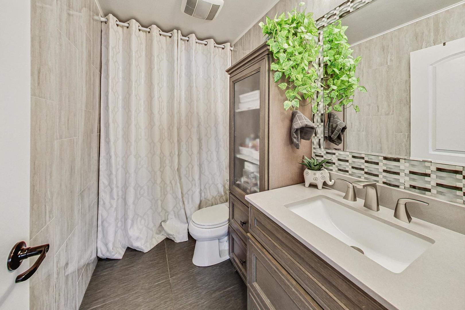 3900 Dundee Road, Unit 104 Northbrook, IL 60062 - Photo 23 of 34 a bathroom with a sink toilet and shower