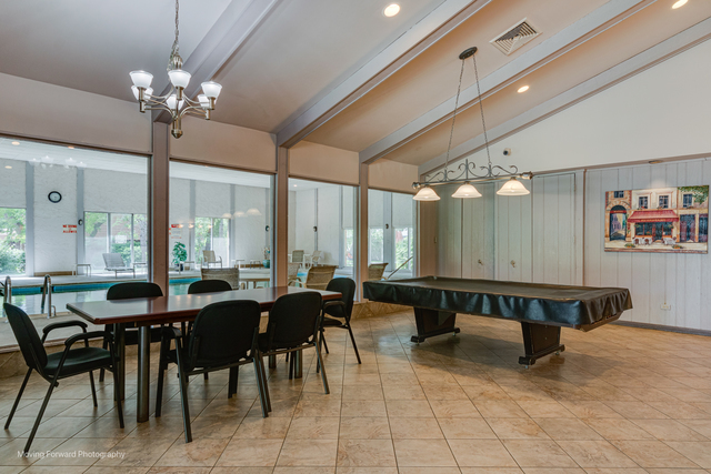 3900 Dundee Road, Unit 104 Northbrook, IL 60062 - Photo 31 of 34 a view of a dining room with furniture and chandelier