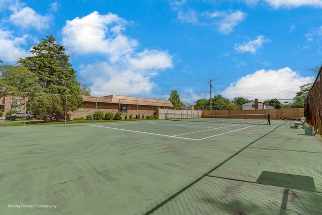3900 Dundee Road, Unit 104 Northbrook, IL 60062 - Photo 33 of 34 a view of a tennis ground with large trees
