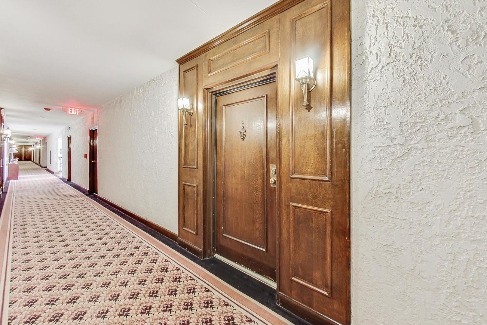 3900 Dundee Road, Unit 104 Northbrook, IL 60062 - Photo 5 of 34 a view of a hallway with wooden floor