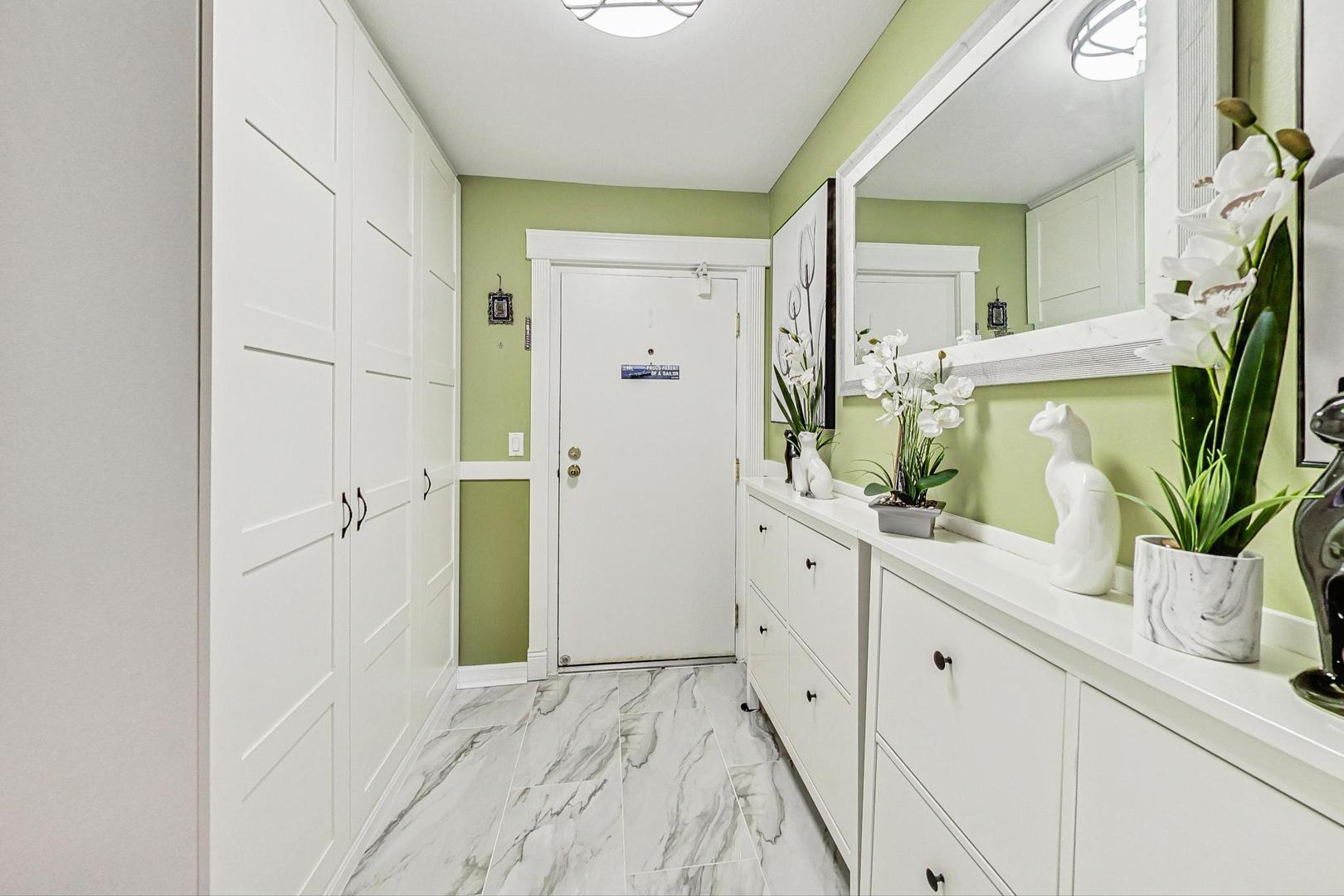3900 Dundee Road, Unit 104 Northbrook, IL 60062 - Photo 7 of 34 a bathroom with a double vanity sink and mirror