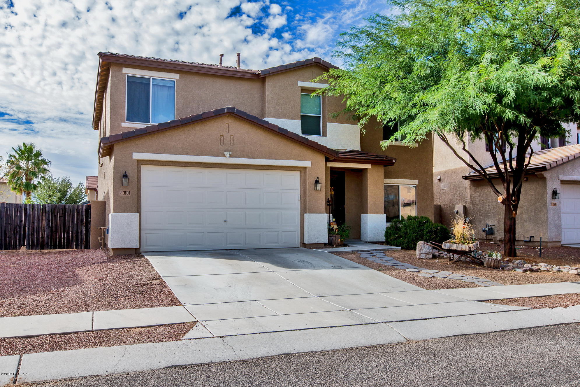 3600 East Mecate Road Tucson, AZ 85739 - Photo 1 of 39 a front view of a house with a yard and garage