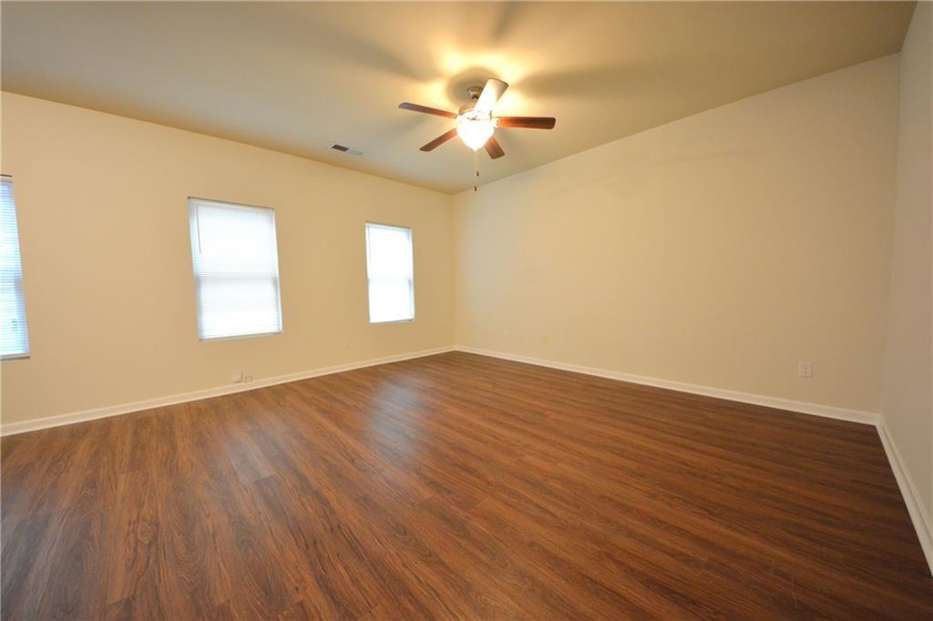 4305 Traipse Path Ellenwood, GA 30294 - Photo 13 of 36 a view of an empty room with wooden floor and a window