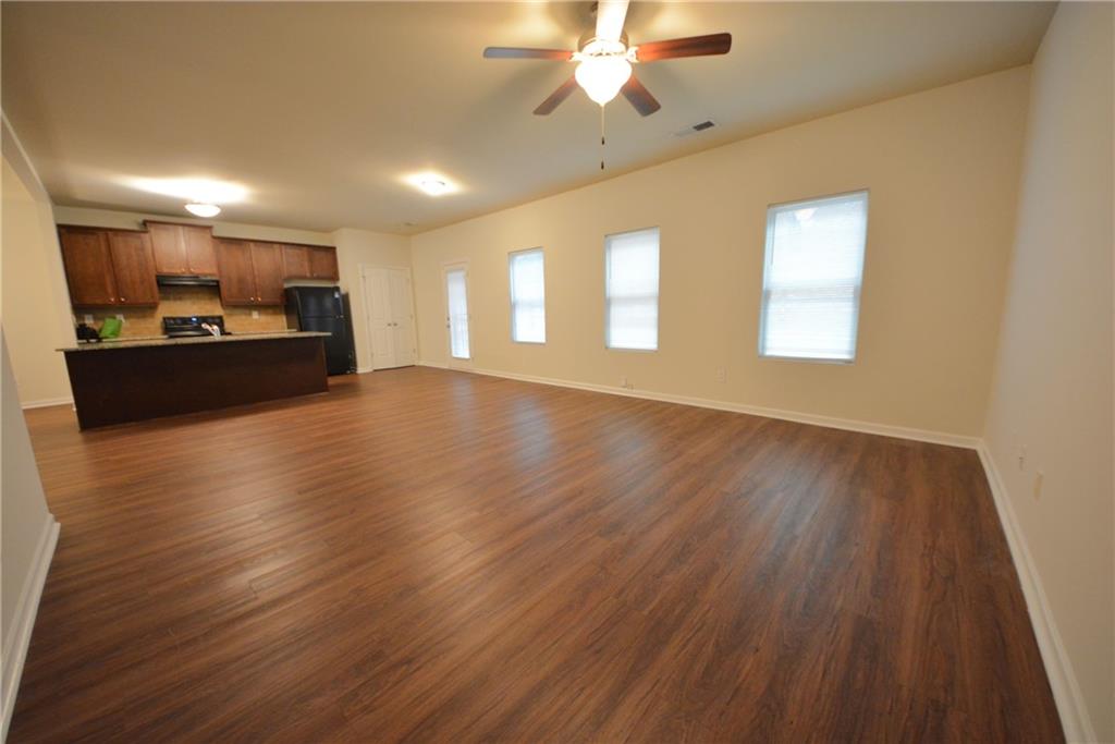 4305 Traipse Path Ellenwood, GA 30294 - Photo 15 of 36 a view of a room with wooden floor and a ceiling fan
